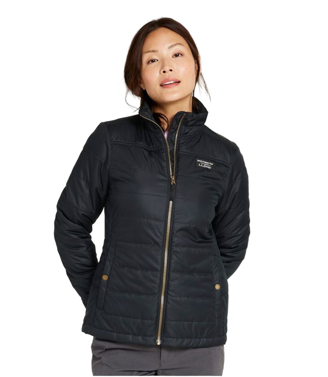 Woman wearing a black jacket with a visible brand logo on a white background