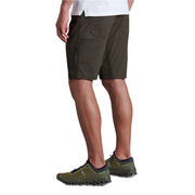 Person wearing green shorts and hiking shoes on a white background