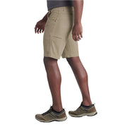 Person wearing beige cargo shorts on a white background