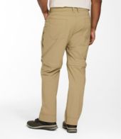 Beige pants worn by a person on a white background