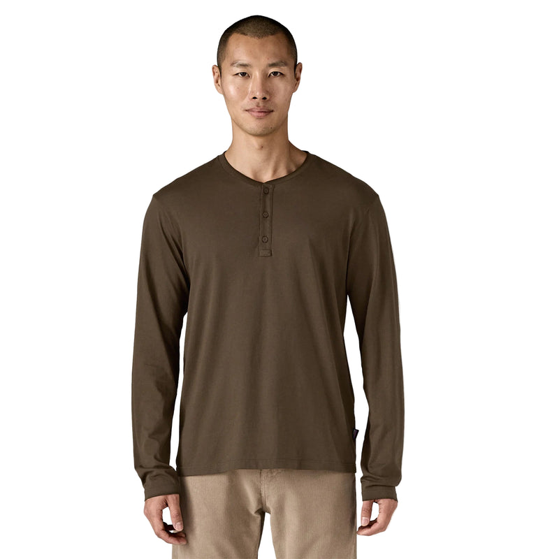 Man wearing a brown long-sleeve henley shirt on a white background