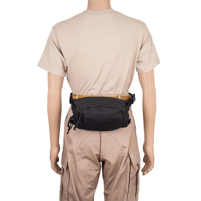 A black tactical waist bag worn around the waist of a mannequin dressed in a beige t-shirt and cargo pants, shown from the back against a white background.