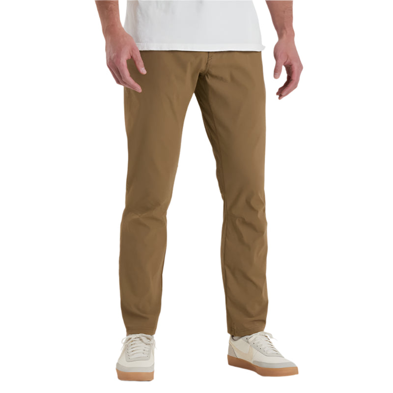Person wearing tan pants and white sneakers on a white background