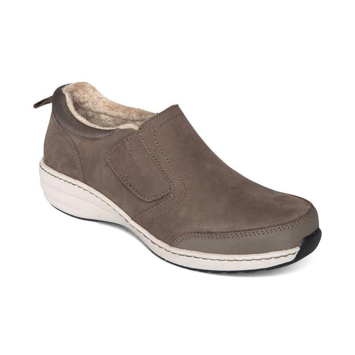 A brown slip in shoe with a white bottom on a white background