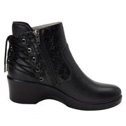 Side view of a black ankle boot with a lace pattern on the back against a white background. 
