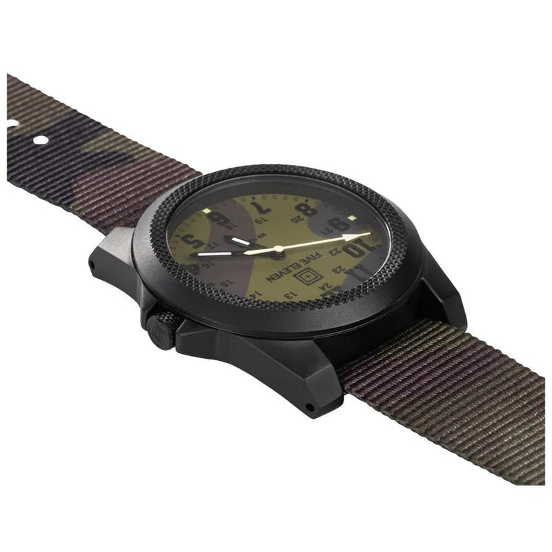 A camo patterned watch with a dial on the side on a white background