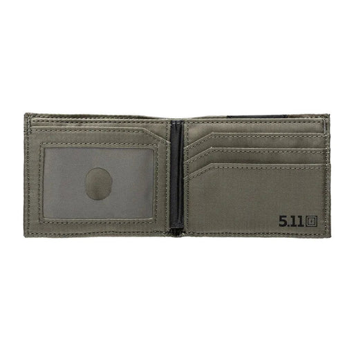A open black camo wallet with a greenish inside on a white background