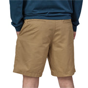 Person wearing brown shorts and a blue sweatshirt on a white background