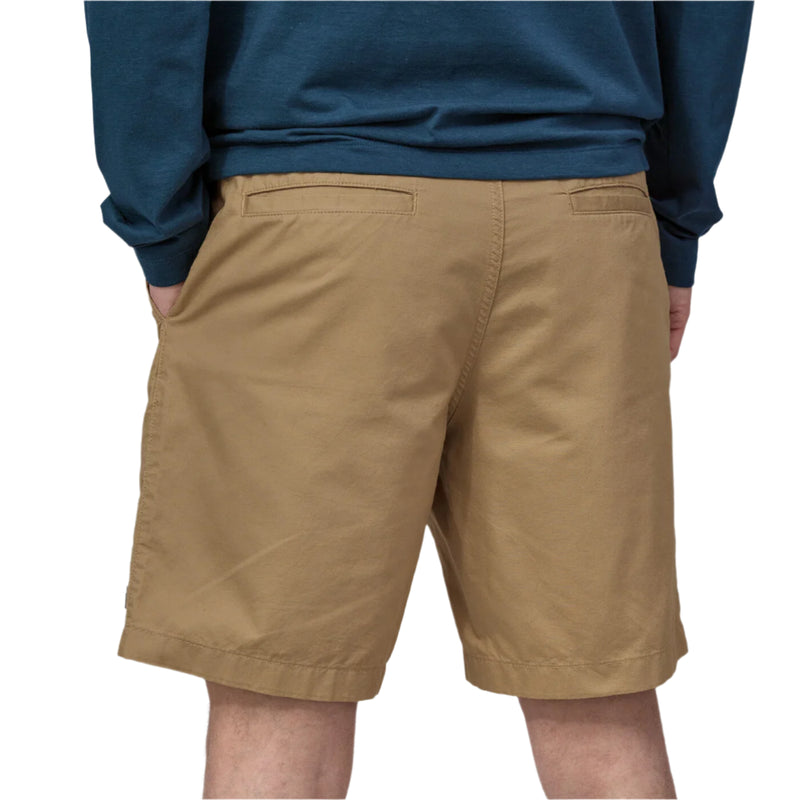 Person wearing brown shorts and a blue sweatshirt on a white background