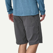 Person wearing gray shorts and a blue long-sleeve shirt on a white background