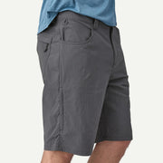 Gray shorts worn by a person on a white background