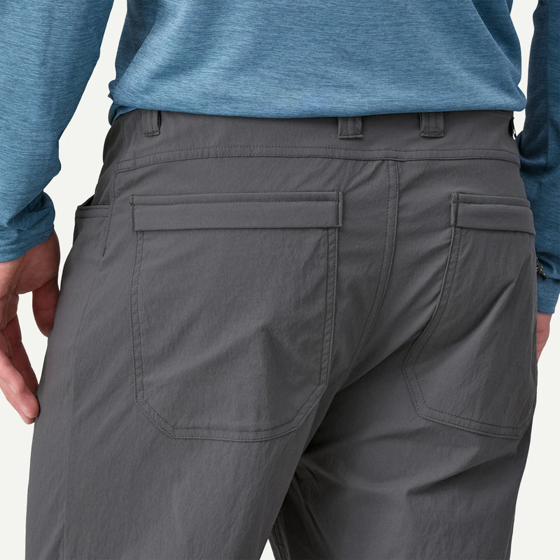 Gray pants worn by a person with a blue shirt on a white background