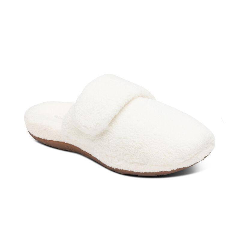 A white fuzzy slipper on a white background