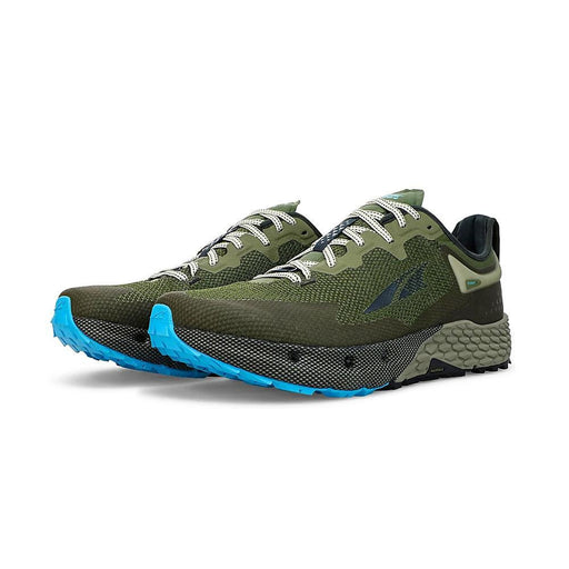 A pair of green running shoes with light blue bottoms on a white background