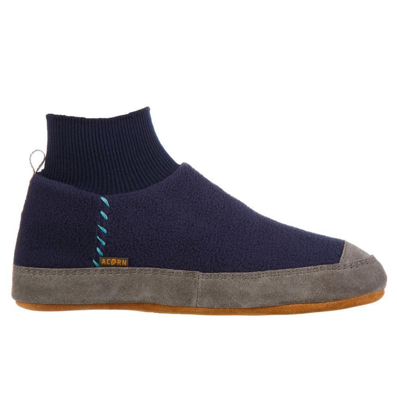 A blue and black slipper with a gray bottom on a white background