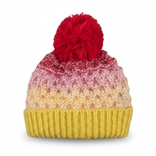Red and yellow knit pom pom beanie against a white background. 