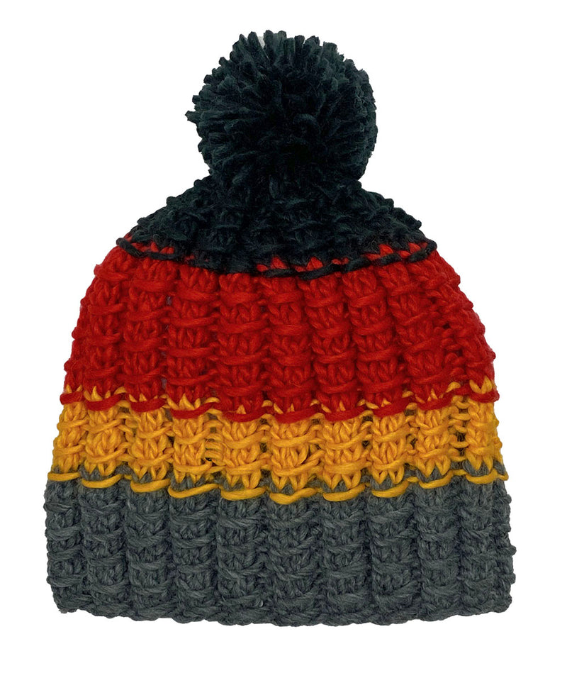 Grey, yellow, and red knit pom pom beanie against a white background. 