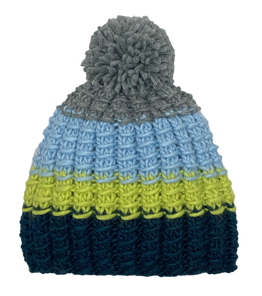 Navy, green, and blue knit pom pom beanie against a white background.