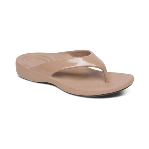 A tan flip flop on a white background
