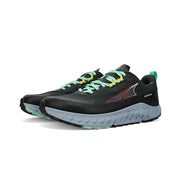 A pair of black running shoes with teal laces and gray bottoms on a white background
