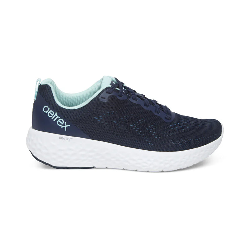 Navy running shoe with white sole on a white background