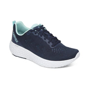 Navy running shoe with white sole on a white background