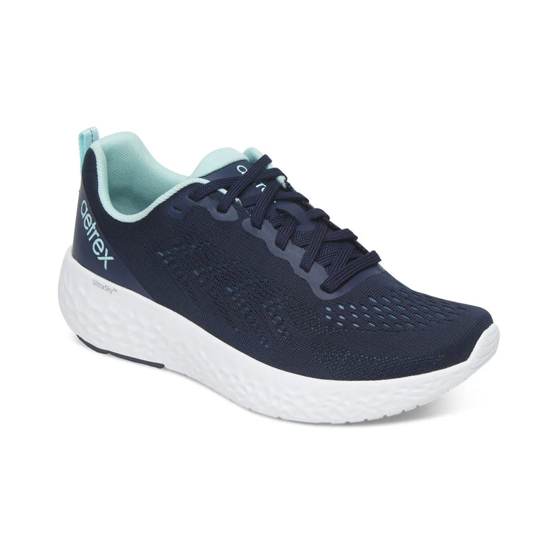 Navy running shoe with white sole on a white background