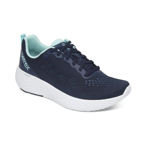 Navy running shoe with white sole on a white background