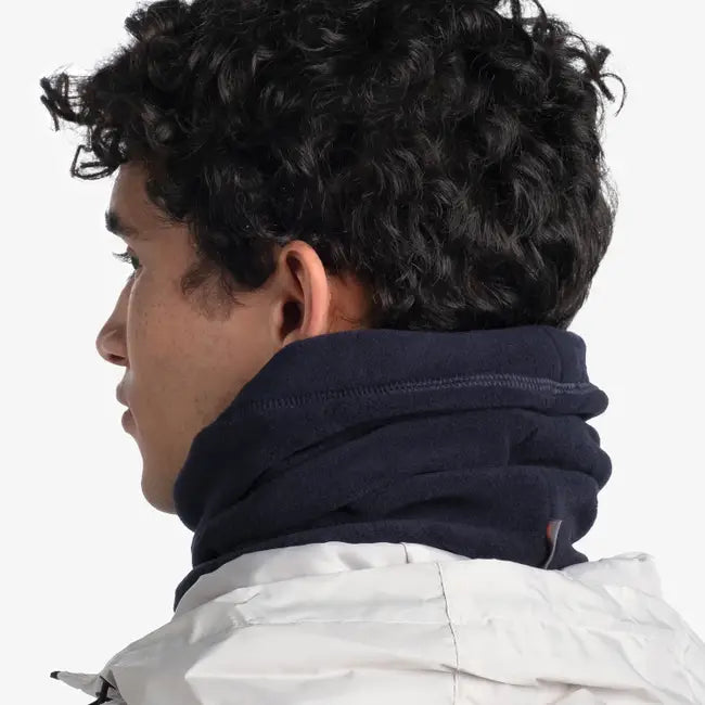 Person wearing a dark blue neck gaiter on a white background, shown from behind