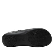 Black shoe sole with brand logo on a light gray background