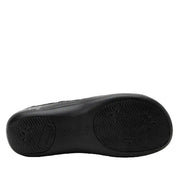 Black shoe sole with brand logo on a light gray background