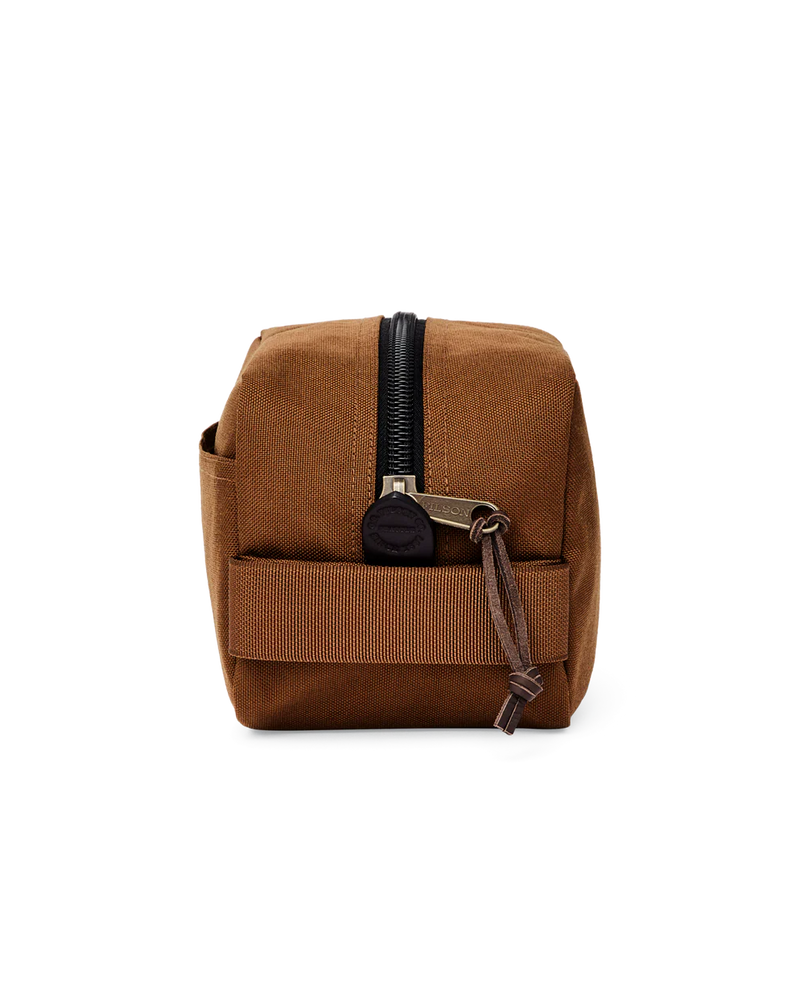 Light brown travel bag against a white background. 