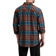 Man wearing a brown and blue plaid shirt on a white background