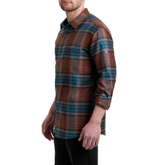 Person wearing a brown and blue plaid shirt on a white background