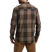 Man wearing a plaid shirt and brown pants on a white background