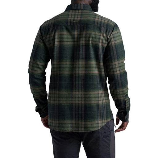 Person wearing a green plaid shirt on a white background