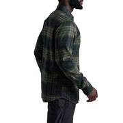Man wearing a green plaid shirt on a white background