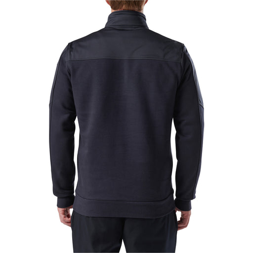 The back of a person wearing a dark navy blue shirt on a white background