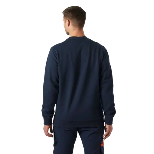 Man wearing a navy blue tracksuit on a white background