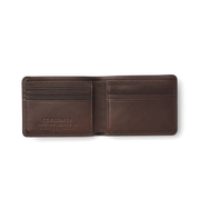 Opened up dark brown leather wallet against a white background. 