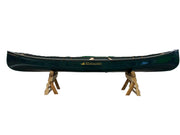 Green canoe with a wooden stand on a white background