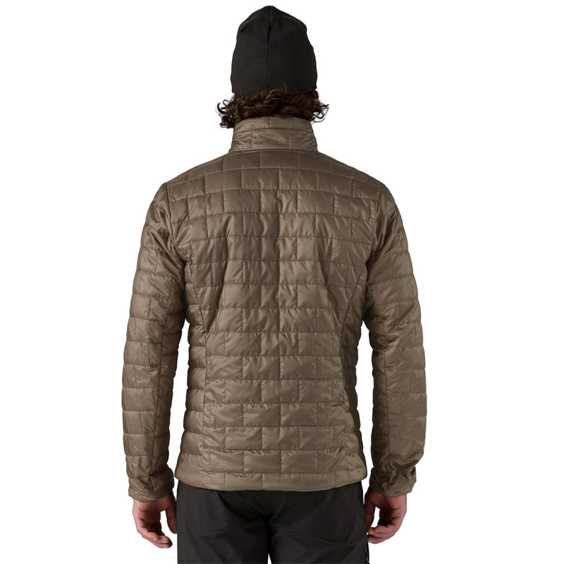Person wearing a brown quilted jacket on a white background