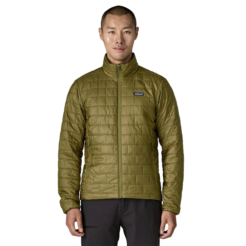 Man wearing a Patagonia Nano Puff quilted jacket  in Pond Green with a visible brand logo on a white background. Patagonia style 84213 Pond Green Packable puffer jacket