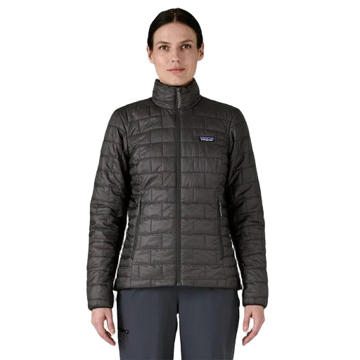 Person wearing a dark gray quilted jacket with a brand logo on a light gray background