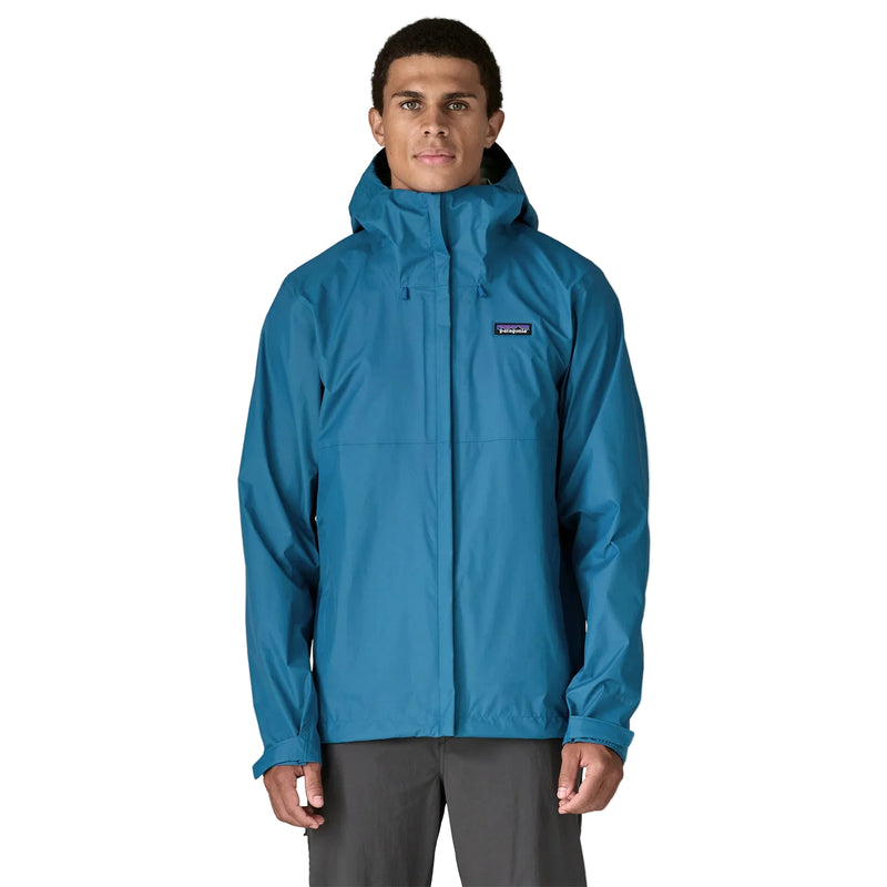 A person from the front wearing a blue rain jacket on a white background