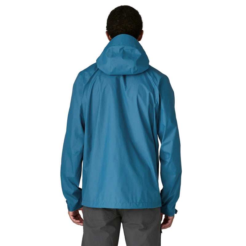 A person from behind wearing a blue rain jacket on a white background