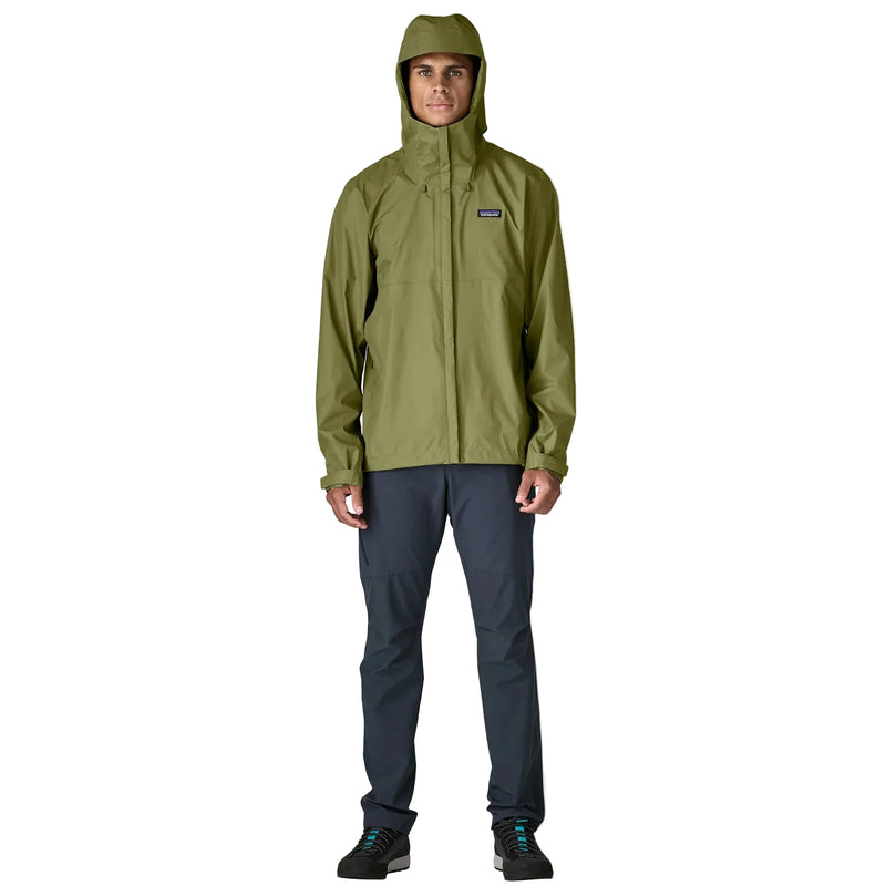 A person wearing a green rain jacket with the hood up on a white background