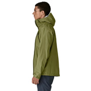A person from the side wearing a green rain jacket on a white background
