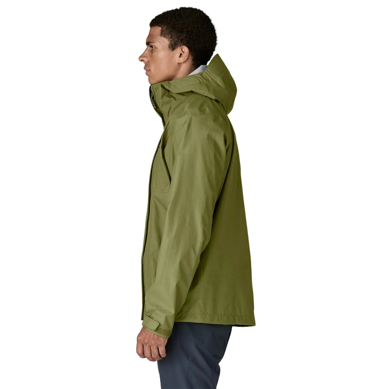 A person from the side wearing a green rain jacket on a white background