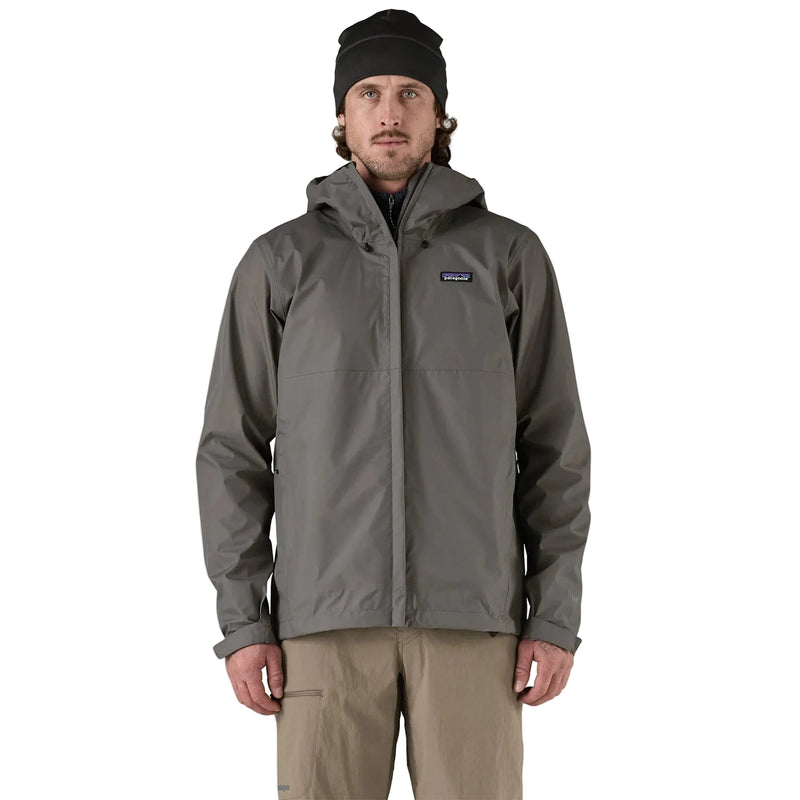 Man wearing a gray rain jacket with a brand logo on a white background